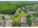 Scenic aerial view of the home surrounded by lush trees and a tranquil lake in the neighborhood at 1902 Hanson Ct # 308, Sun City Center, FL 33573