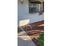Exterior view of the building with a small mulch bed and a window at 2017 Skimmer W Ct # 413, Clearwater, FL 33762