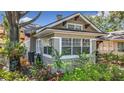 A detailed exterior view reveals brick accents and lush landscaping around the property at 231 15Th Ne Ave, St Petersburg, FL 33704