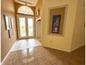 Bright foyer featuring tile flooring, high ceilings, and decorative wall art at 2349 Wood Pointe Dr, Holiday, FL 34691