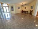 Open-concept living space with tile floors, art, and natural light at 2349 Wood Pointe Dr, Holiday, FL 34691