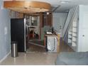 Kitchen remodel, featuring a stainless steel refrigerator, open ceiling and tile flooring at 2980 Haines Bayshore Rd # 124, Clearwater, FL 33760