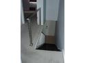 Carpeted stairway with modern railing and adjacent door at 2980 Haines Bayshore Rd # 124, Clearwater, FL 33760