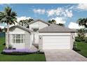 Beautifully landscaped home featuring a large driveway and neutral stucco exterior with brick accents at 3198 Malta Ave, Wesley Chapel, FL 33543