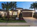 Well-manicured lawn and landscaping frame this house that features a brick driveway and decorative mailbox at 3198 Malta Ave, Wesley Chapel, FL 33543