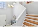 Bright staircase with wooden treads and a modern light fixture at 3205 W De Leon St # F, Tampa, FL 33609