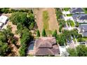 An aerial view displays the home's backyard, including a screened pool and views of green space at 3323 Anna George Dr, Valrico, FL 33596