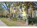 Charming townhome showing lush greenery, mature trees, and a manicured lawn enhance curb appeal at 3456 Castle Stone Ct, Valrico, FL 33594