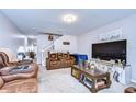 Spacious living room features plush seating, neutral carpet, and ample natural light at 3456 Castle Stone Ct, Valrico, FL 33594