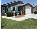 Well-maintained single-story home with manicured lawn, brick accents, and inviting curb appeal at 37401 Teaberry Loop, Zephyrhills, FL 33542