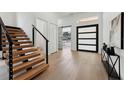 Inviting entryway showcasing a modern staircase, sleek flooring, and a stylish front door at 3817 W San Nicholas St, Tampa, FL 33629