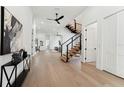 Open-concept foyer features a floating staircase, light wood floors, and leads to other areas of the house at 3817 W San Nicholas St, Tampa, FL 33629