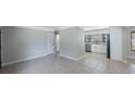Open living area with tiled floor leading to the kitchen at 4558 23Rd N Ave, St Petersburg, FL 33713