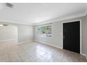 Bright living room with large window offering natural light and tiled flooring throughout at 4558 23Rd N Ave, St Petersburg, FL 33713