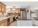 Well-equipped kitchen with stainless steel appliances, light wood cabinets, and a functional center island at 4601 83Rd N Ave, Pinellas Park, FL 33781