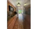 Kitchen with stainless steel appliances, wood cabinets, and granite countertops at 4967 Steel Dust Ln, Lutz, FL 33559