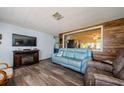 Cozy living room featuring modern flooring and a partial view of the kitchen at 6111 2Nd Ave, New Port Richey, FL 34653