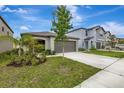 Beautiful home with a well-manicured lawn, two-car garage, and inviting curb appeal in a Gathering-friendly neighborhood at 7225 Ronnie Gardens Ct, Tampa, FL 33619