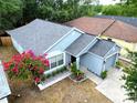 An aerial shot captures the single-story home with gray roof and landscaped front yard at 759 Cape Cod Cir, Valrico, FL 33594