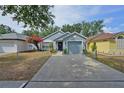 Charming single-story home featuring a beautiful flower tree, attached garage, and a welcoming front door with a wreath at 759 Cape Cod Cir, Valrico, FL 33594