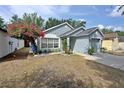 Charming single-story home featuring a beautiful flower tree, attached garage, and a welcoming front door with a wreath at 759 Cape Cod Cir, Valrico, FL 33594
