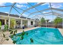 Enclosed in-ground pool with seating area, ideal for relaxation and recreation at 8737 Beaver Ln, Port Richey, FL 34668