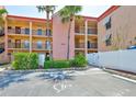 Condo exterior showing well-maintained landscaping, assigned parking, and building access at 8931 Blind Pass Rd # 262, St Pete Beach, FL 33706