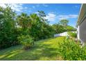 Spacious backyard with lush green lawn and privacy fence, perfect for outdoor activities and relaxation at 9059 Spruce Creek Cir, Riverview, FL 33578