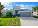 Well-maintained home with a two-car garage, beautiful landscaping, and a welcoming front entrance at 9059 Spruce Creek Cir, Riverview, FL 33578