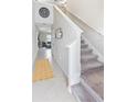 Inviting entryway with neutral tones, tiled floors, and a staircase leading to the upper level at 9313 Lemon Drop Loop, Sun City Center, FL 33573
