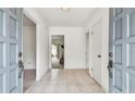 Light and airy foyer with neutral tile flooring, offering a view into other rooms at 103 Hickory Creek Blvd, Brandon, FL 33511