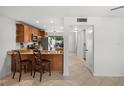 Spacious eat-in kitchen featuring granite countertops, wood cabinetry and an eat in breakfast bar at 108 Biscayne Ave # B, Tampa, FL 33606