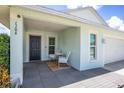 Cozy front porch featuring modern chairs and a table, offering a welcoming entrance to the home at 1106 Humble Haven St, Ruskin, FL 33570