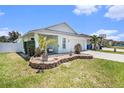 Charming single-story home with a well-manicured lawn, a small patio, and an attached garage at 1106 Humble Haven St, Ruskin, FL 33570