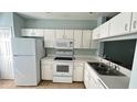 Functional kitchen with white appliances, ample cabinet space, and a practical layout at 1400 Costa Mesa Dr, Wesley Chapel, FL 33543