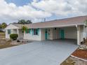 Charming single-story home featuring a long driveway and carport at 1509 Cherry Hills Dr, Sun City Center, FL 33573