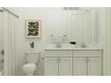 Well-lit bathroom featuring a double sink vanity with elegant fixtures and stylish decor at 16941 Falling Waters Ct, Land O Lakes, FL 34638