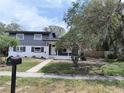 Charming two-story home with freshly painted exterior and mature trees in the front yard at 1907 E 111Th Ave, Tampa, FL 33612