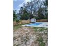 Backyard featuring an in-ground pool and a wooden fence at 1907 E 111Th Ave, Tampa, FL 33612