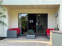 Outdoor patio with sliding glass door and stylish red furniture at 29129 Bay Hollow Dr # 3201, Wesley Chapel, FL 33543