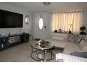 Comfortable living room featuring a large TV, modern decor, and inviting ambiance at 3424 Truman Dr, Holiday, FL 34691