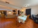 Inviting dining area with hardwood floors, open to the living room, ideal for Gathering gatherings at 35058 Whispering Oaks Blvd, Dade City, FL 33523