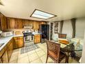 Functional kitchen featuring wooden cabinets, stainless steel appliances, and an adjacent dining area at 35058 Whispering Oaks Blvd, Dade City, FL 33523