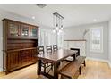 Open dining area with hardwood floors, pendant lighting, and fireplace at 493 Lucerne Ave, Tampa, FL 33606