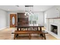 Open dining area with hardwood floors, pendant lighting, and fireplace at 493 Lucerne Ave, Tampa, FL 33606