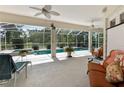Covered patio offers ample seating, views of the screened-in pool and backyard, perfect for relaxation at 5182 Championship Cup Ln, Spring Hill, FL 34609