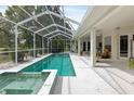 Screened-in pool features a spa and a spacious deck area, ideal for outdoor entertaining at 5182 Championship Cup Ln, Spring Hill, FL 34609