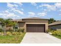 Inviting single story home with manicured landscaping and a two-car garage at 5518 Blue Azure Dr, Wimauma, FL 33598