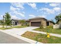 Charming single-Gathering home featuring a well-maintained lawn and two car garage at 5518 Blue Azure Dr, Wimauma, FL 33598