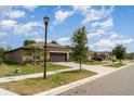 Attractive one-story home with a two-car garage and fresh landscaping at 5518 Blue Azure Dr, Wimauma, FL 33598